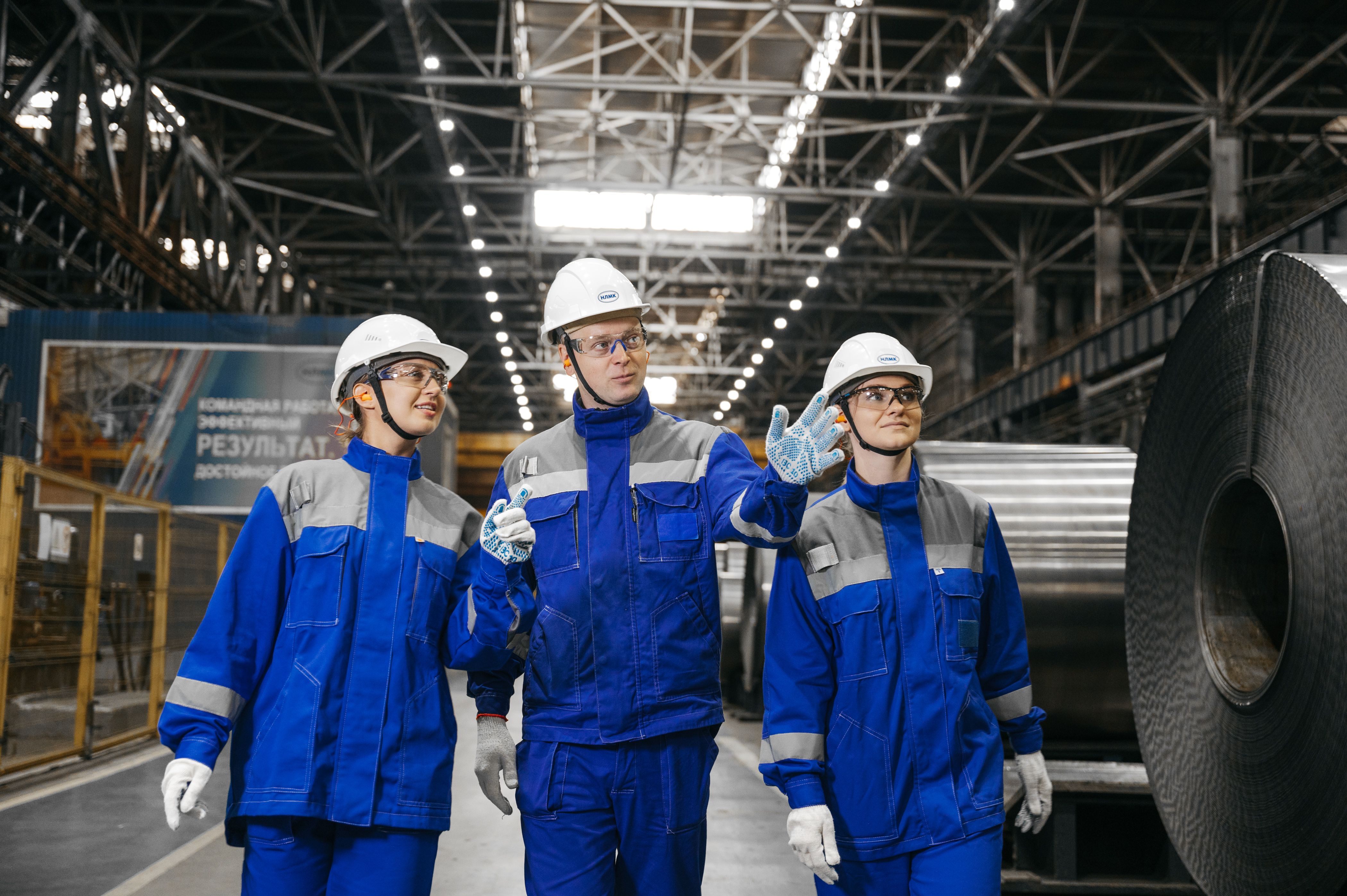 Group of workers in safety gear at steel factory